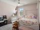 Cozy bedroom showcases a four-poster bed, soft carpet, ceiling fan, and a view from the window at 13205 Arkendale St, Spring Hill, FL 34609