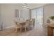 Well-lit dining room features a neutral color palette, tile flooring and a sliding glass door at 13205 Arkendale St, Spring Hill, FL 34609