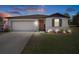 Charming single-story home with a well-manicured lawn, two car garage and inviting curb appeal at 13205 Arkendale St, Spring Hill, FL 34609
