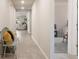 Bright hallway showcasing neutral walls, tile flooring, and access to other rooms in the home at 13205 Arkendale St, Spring Hill, FL 34609