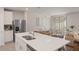 Open concept kitchen island with stainless steel sink overlooking the dining and living areas at 13205 Arkendale St, Spring Hill, FL 34609