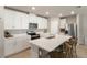 Bright kitchen featuring white cabinetry, stainless steel appliances, and a center island with seating at 13205 Arkendale St, Spring Hill, FL 34609