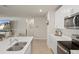 Kitchen with stainless steel appliances and white cabinetry, flowing into the living space at 13205 Arkendale St, Spring Hill, FL 34609