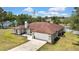 Aerial view of the home with a spacious driveway and manicured landscaping at 13373 Lawrence St, Spring Hill, FL 34609