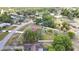 Expansive aerial view showcases a well-maintained property with a sparkling pool, lush landscaping, and a fenced backyard at 13373 Lawrence St, Spring Hill, FL 34609