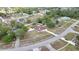 Aerial view of a lovely home with a fenced yard and screened pool on a tree-lined street in a quiet neighborhood at 13373 Lawrence St, Spring Hill, FL 34609
