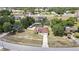 A peaceful street shot with homes nestled in green areas under a partly cloudy sky at 13373 Lawrence St, Spring Hill, FL 34609