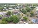 Aerial view features a beautiful home with a screened pool, outdoor seating area, and a well-manicured, fenced yard at 13373 Lawrence St, Spring Hill, FL 34609