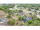 Aerial shot reveals a comfortable home with a private screened pool, fenced yard, and plenty of mature trees at 13373 Lawrence St, Spring Hill, FL 34609