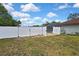 A fenced-in backyard leads to a screened-in pool, creating a private outdoor space at 13373 Lawrence St, Spring Hill, FL 34609