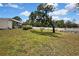 Beautiful backyard featuring a white fence, mature trees, and lush greenery, perfect for outdoor enjoyment at 13373 Lawrence St, Spring Hill, FL 34609