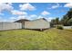 Spacious backyard featuring a white fence, lush green lawn, and ample space for outdoor activities at 13373 Lawrence St, Spring Hill, FL 34609