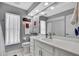 Well-lit bathroom features a single vanity with white cabinets and a large mirror at 13373 Lawrence St, Spring Hill, FL 34609