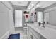 Nicely lit bathroom featuring a single vanity with white cabinets and a large mirror at 13373 Lawrence St, Spring Hill, FL 34609