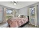 Comfortable bedroom with large window and natural light, complemented by neutral tones and ceiling fan at 13373 Lawrence St, Spring Hill, FL 34609