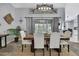 Elegant dining area with a wooden table, upholstered chairs, and unique overhead lighting at 13373 Lawrence St, Spring Hill, FL 34609
