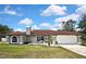 Attractive single-story home featuring a well-manicured lawn and a spacious two-car garage at 13373 Lawrence St, Spring Hill, FL 34609