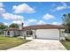 Beautiful single-story home with a well-maintained lawn and attached two-car garage at 13373 Lawrence St, Spring Hill, FL 34609