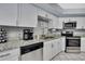 Bright kitchen with white cabinets, granite countertops, and stainless steel appliances at 13373 Lawrence St, Spring Hill, FL 34609