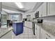Bright kitchen with white cabinets, granite countertops, and an island with a butcher block top at 13373 Lawrence St, Spring Hill, FL 34609