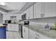 Well-lit kitchen with white cabinets, sleek appliances, and ample counter space for cooking at 13373 Lawrence St, Spring Hill, FL 34609