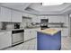 Updated kitchen featuring white cabinets, stainless appliances, and a butcher block island at 13373 Lawrence St, Spring Hill, FL 34609