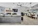 Open-concept living room with a fireplace, large TV, and dining area with stylish furnishings at 13373 Lawrence St, Spring Hill, FL 34609