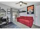 Inviting office/den with a comfortable red couch, decor, and a view of the outdoor pool at 13373 Lawrence St, Spring Hill, FL 34609
