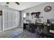 Well-lit office/den with a black desk, storage and a wall of awards and decor at 13373 Lawrence St, Spring Hill, FL 34609