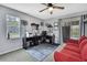 Versatile office/den space with gray walls, ceiling fan, and sliding glass doors to the outdoor pool at 13373 Lawrence St, Spring Hill, FL 34609