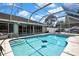 Screened in swimming pool with steps and a patio area perfect for relaxation at 13373 Lawrence St, Spring Hill, FL 34609