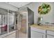Close up view of wet bar with stainless steel refrigerator and overhead cabinets at 13373 Lawrence St, Spring Hill, FL 34609