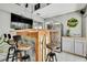 A wet bar featuring a wood countertop, metal accents, barstools, and a refrigerator at 13373 Lawrence St, Spring Hill, FL 34609
