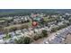 Neighborhood aerial showcasing a vibrant community with mature trees and a tranquil pond at 13524 Knotty Ln, Hudson, FL 34669
