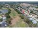 Real estate aerial view overlooking a golf course, lakes and a vibrant residential neighborhood at 13524 Knotty Ln, Hudson, FL 34669