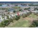 Scenic aerial view of a suburban neighborhood with multiple lakes, golf course, and lush green landscape at 13524 Knotty Ln, Hudson, FL 34669
