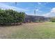 Spacious backyard featuring a large screened enclosure and manicured landscaping at 13524 Knotty Ln, Hudson, FL 34669