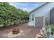Backyard featuring storage shed, fire pit, and mature landscaping at 13524 Knotty Ln, Hudson, FL 34669