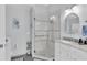 Bathroom features glass shower with decorative tile work and granite countertop vanity at 13524 Knotty Ln, Hudson, FL 34669