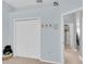 Bedroom with a large closet, coat rack, and light-blue walls at 13524 Knotty Ln, Hudson, FL 34669