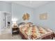 Comfortable guest bedroom with a decorative quilt and easy access at 13524 Knotty Ln, Hudson, FL 34669