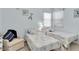 Shared bedroom with two twin beds, sea-themed decor, and ample sunlight at 13524 Knotty Ln, Hudson, FL 34669