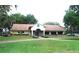 Exterior shot of the community clubhouse with its well-manicured lawn and inviting entrance at 13524 Knotty Ln, Hudson, FL 34669