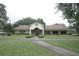 Exterior shot of the community clubhouse with its well-manicured lawn and inviting entrance at 13524 Knotty Ln, Hudson, FL 34669
