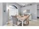 Bright dining area featuring a modern table and chairs, complemented by natural light at 13524 Knotty Ln, Hudson, FL 34669