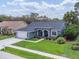 Charming single-Gathering home with a well-manicured lawn and elegant landscaping at 13524 Knotty Ln, Hudson, FL 34669