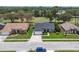 Aerial view of a single Gathering home with a well-manicured front lawn and a blue Jeep parked nearby at 13524 Knotty Ln, Hudson, FL 34669