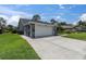 Charming home featuring an attached two-car garage and well-maintained landscaping at 13524 Knotty Ln, Hudson, FL 34669