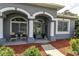 Inviting front porch with decorative columns and seating area, adding curb appeal to the home at 13524 Knotty Ln, Hudson, FL 34669