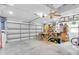 Spacious garage featuring a workbench, storage, and an automatic garage door at 13524 Knotty Ln, Hudson, FL 34669